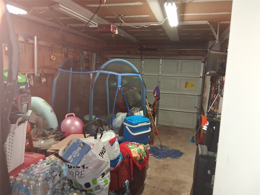 23347 Pebworth Place Spring, TX 77373 - Photo 8 of 10 Spacious garage with ample storage potential, perfect for vehicles, tools, and more.