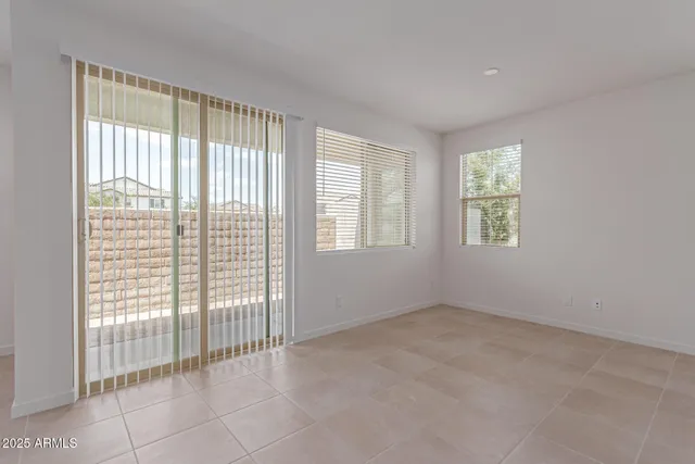a view of an empty room with glass door