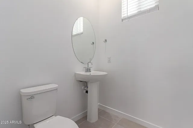 a bathroom with a sink toilet and a mirror