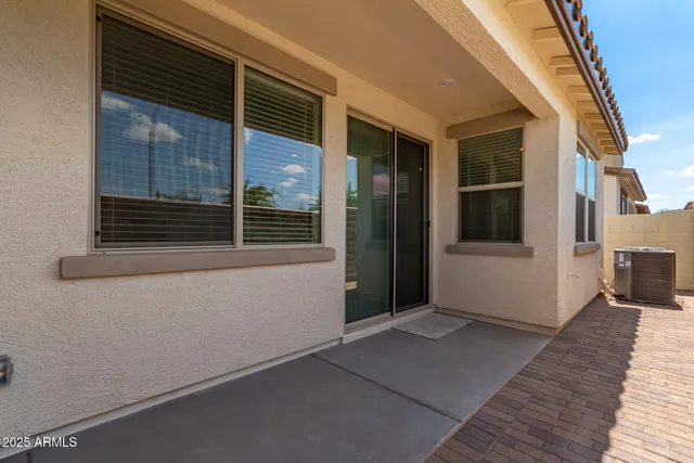 a row of palm trees sitting in front of house