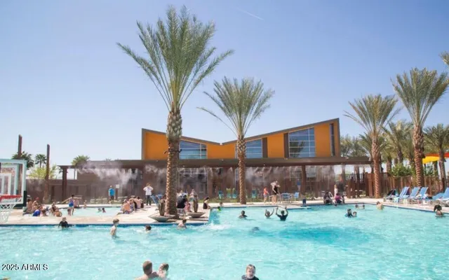 a patio with water view fountain with outdoor seating