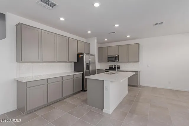 a kitchen with a sink appliances and cabinets