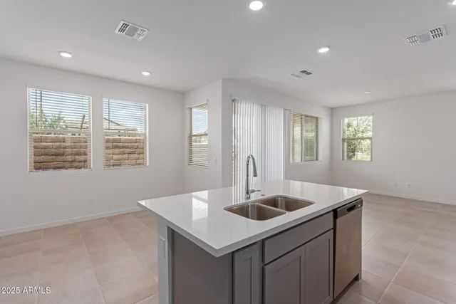a kitchen with a sink cabinets and window