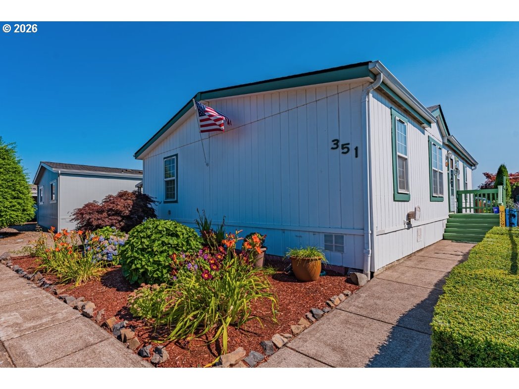 1699 North Terry Street, Unit 351 Eugene, OR 97402 - Photo 2 of 23 a backyard of a house with wooden fence and plants