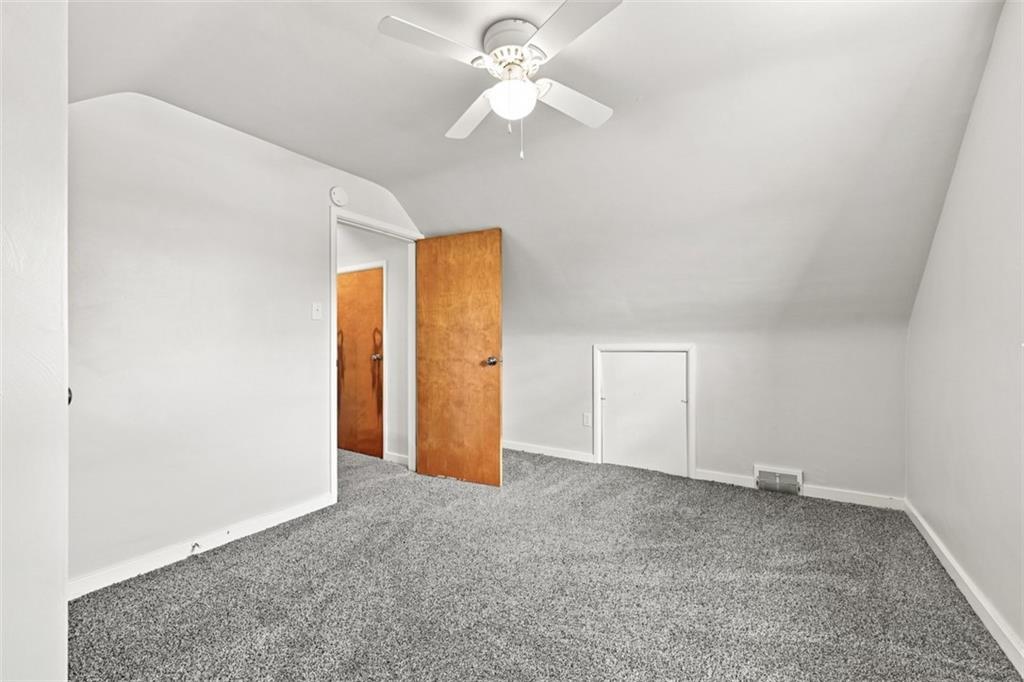 545 Center Hill Road Pittsburgh, PA 15239 - Photo 32 of 48 Natural light fills the room through the window, complemented by a ceiling fan for added comfort.