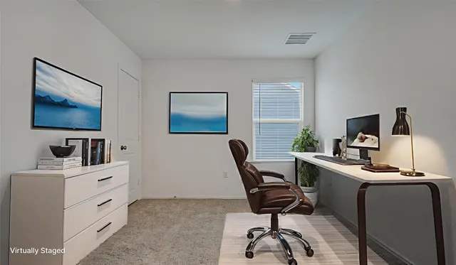 a living room with furniture and view of kitchen