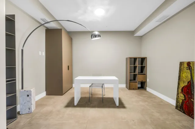 a bedroom with a large bed and a chandelier