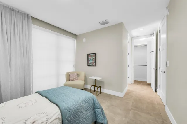a living room with couch and a potted plant