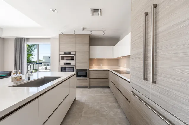 a large white kitchen with a large window