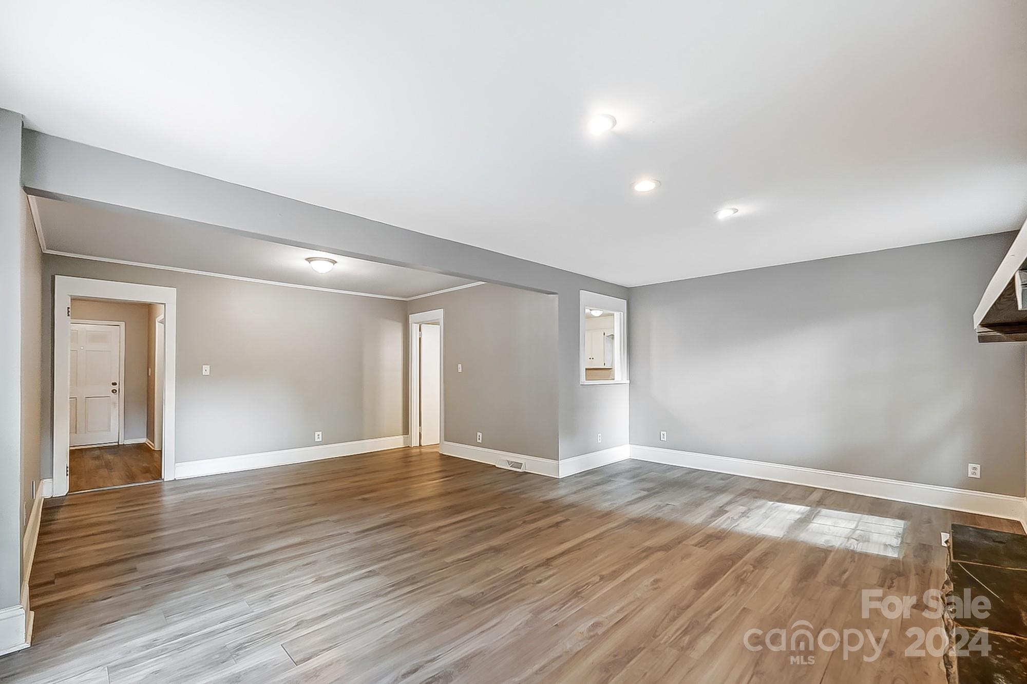 3218 Valley Grove Road Charlotte, NC 28227 - Photo 11 of 23 a view of an empty room with wooden floor and a window
