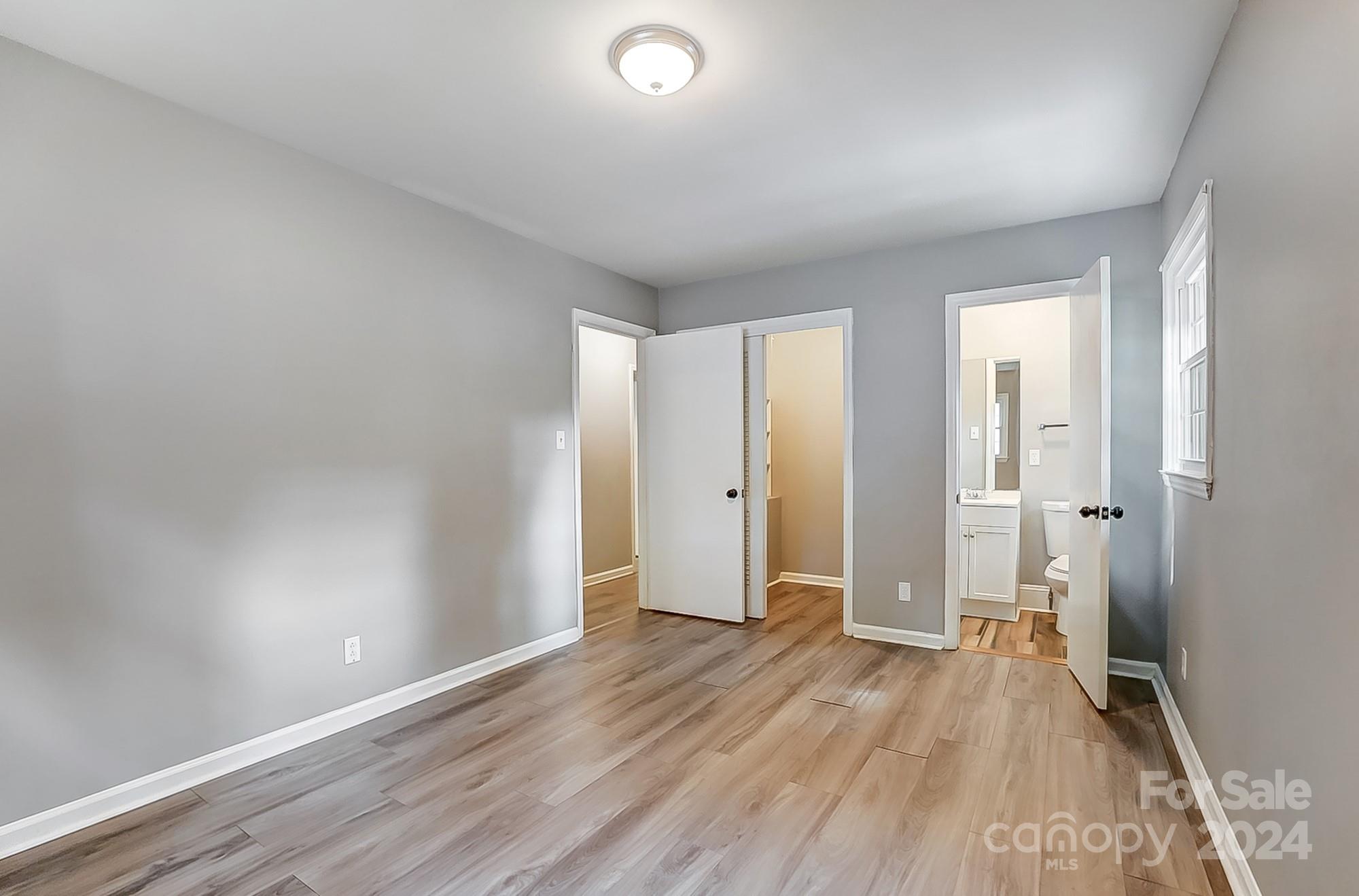 3218 Valley Grove Road Charlotte, NC 28227 - Photo 13 of 23 wooden floor in an empty room with a window