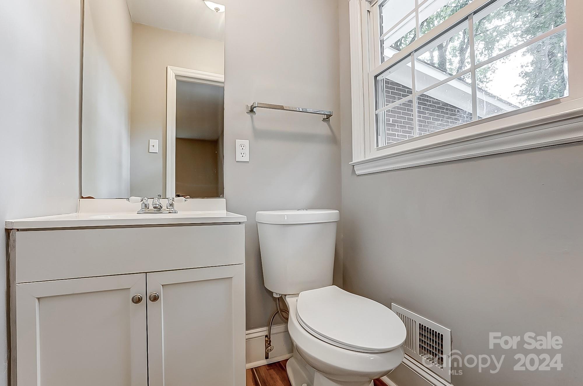 3218 Valley Grove Road Charlotte, NC 28227 - Photo 14 of 23 a bathroom with a toilet a sink and a mirror