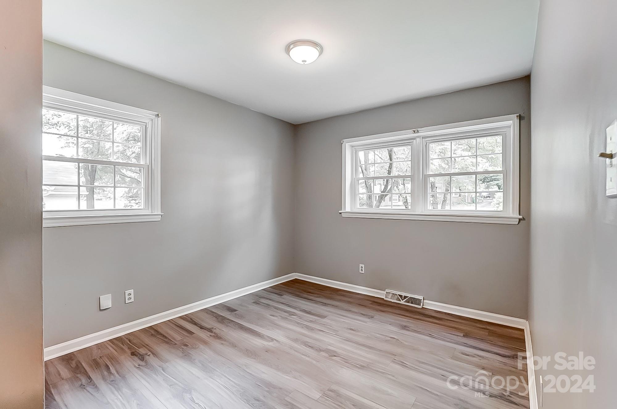 3218 Valley Grove Road Charlotte, NC 28227 - Photo 15 of 23 an empty room with wooden floor and windows