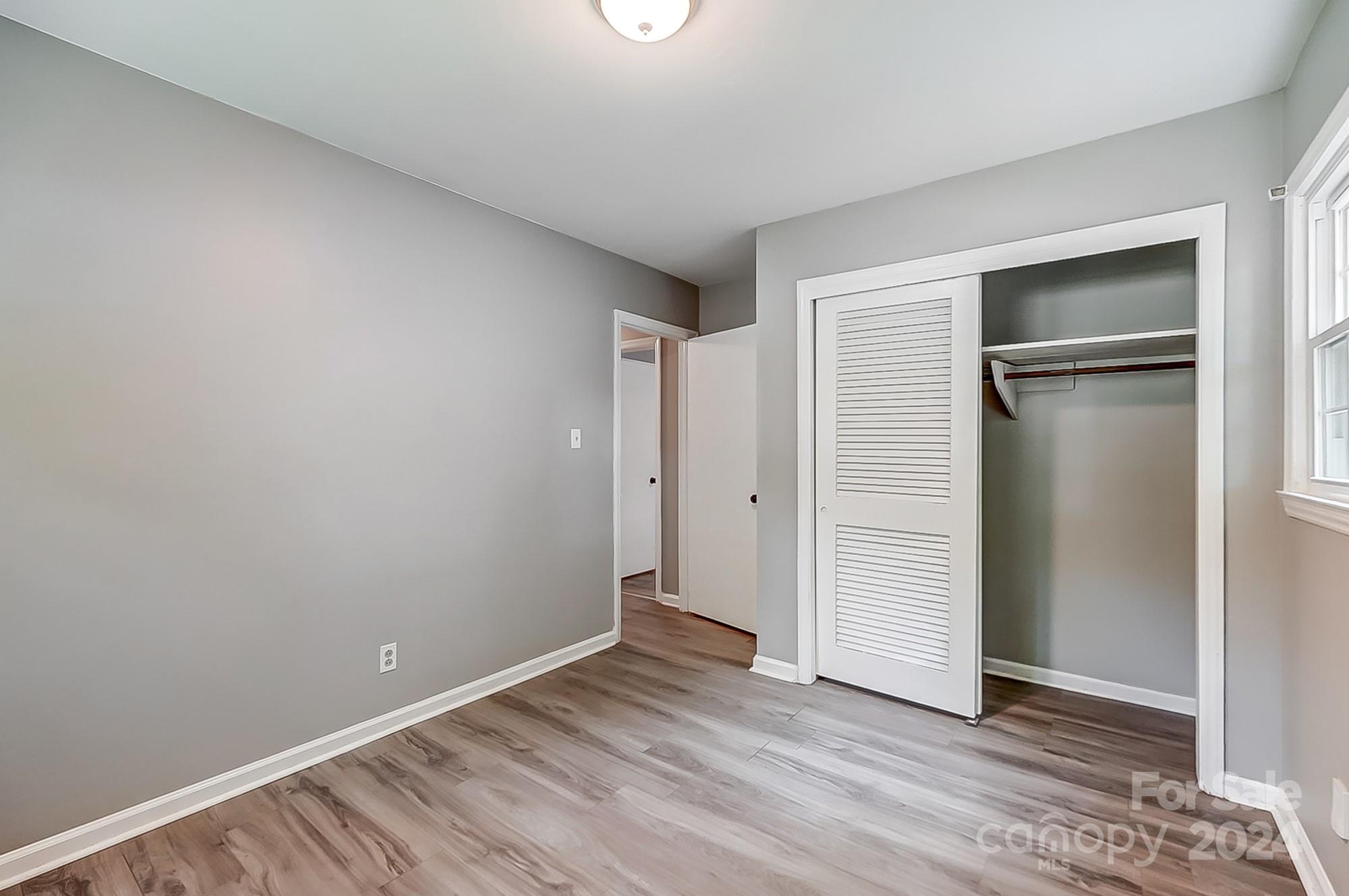 3218 Valley Grove Road Charlotte, NC 28227 - Photo 16 of 23 a view of an empty room with closet and wooden floor