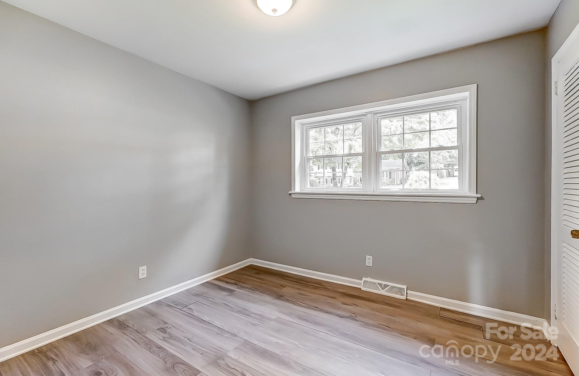 3218 Valley Grove Road Charlotte, NC 28227 - Photo 18 of 23 a room with window and wooden floor