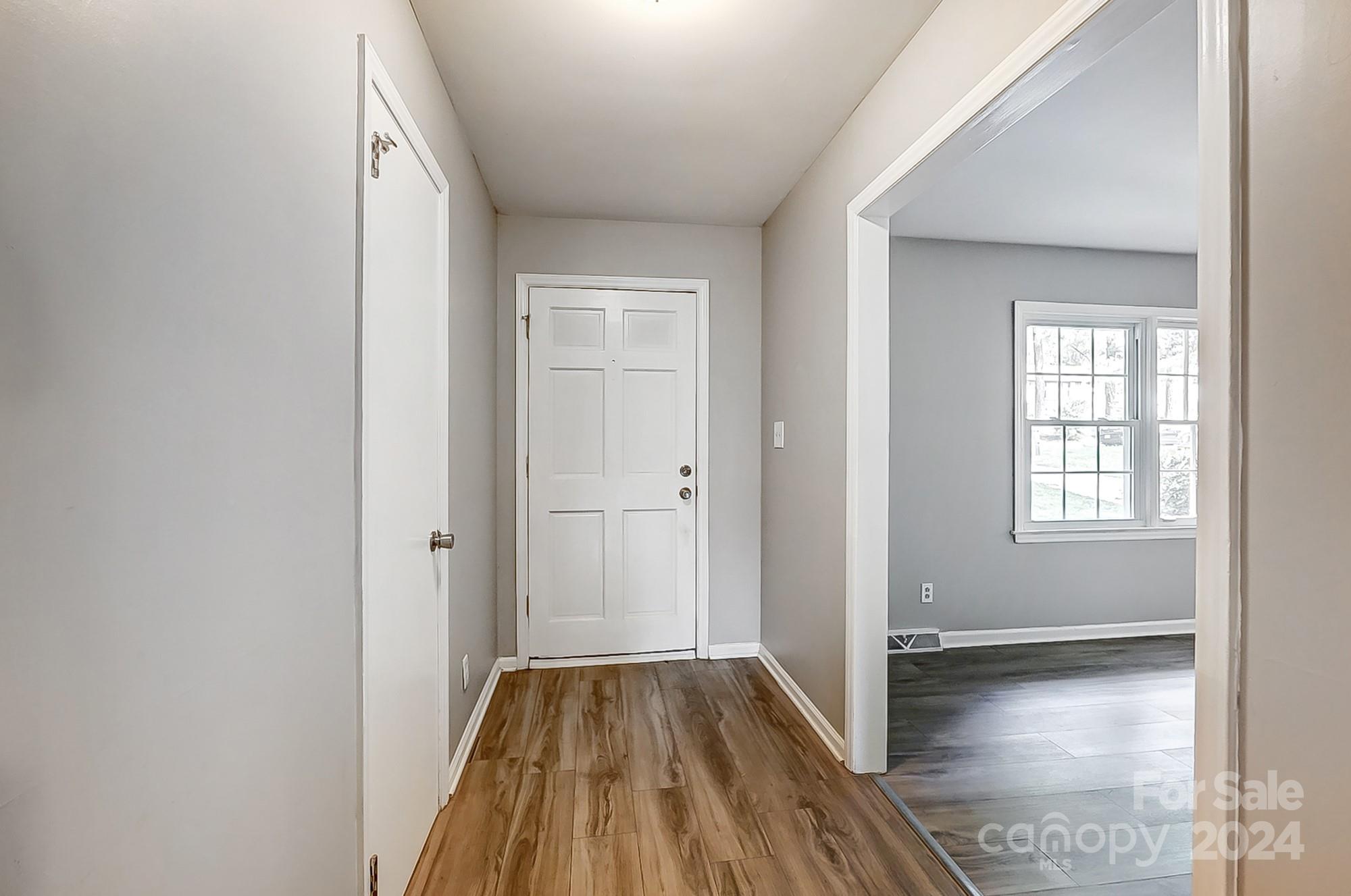 3218 Valley Grove Road Charlotte, NC 28227 - Photo 2 of 23 wooden floor in an empty room with a window