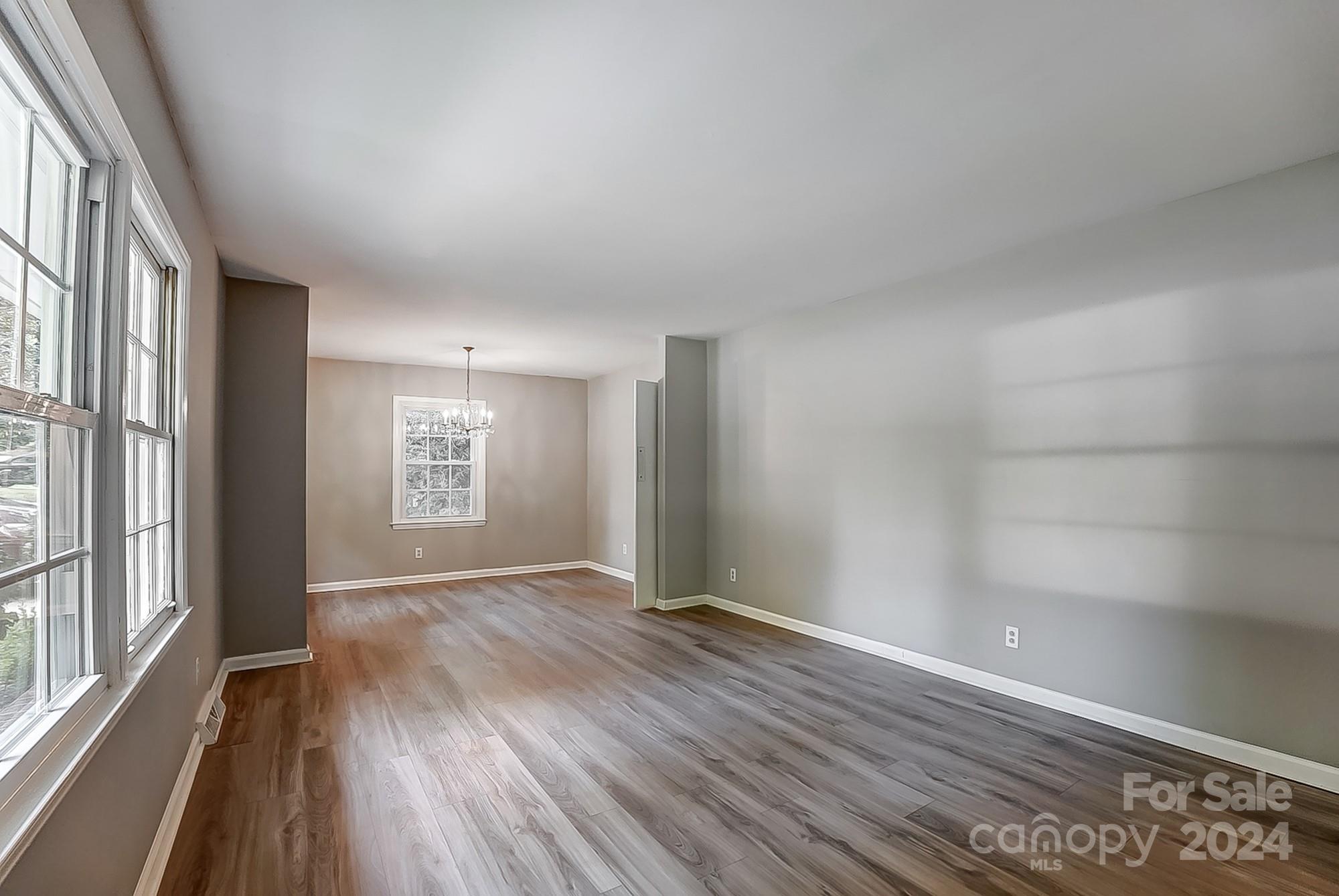 3218 Valley Grove Road Charlotte, NC 28227 - Photo 3 of 23 wooden floor in an empty room with a window