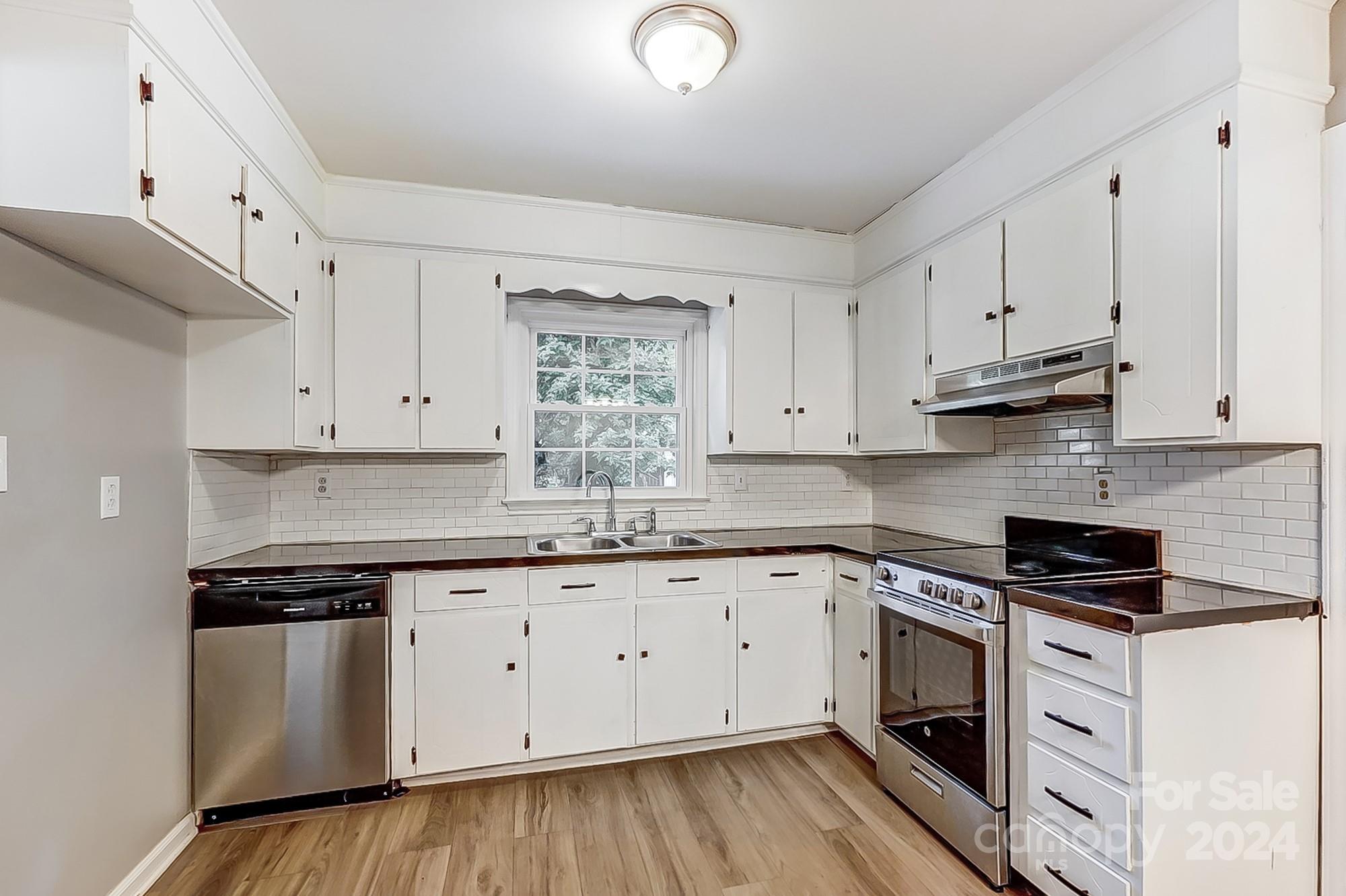 3218 Valley Grove Road Charlotte, NC 28227 - Photo 5 of 23 a kitchen with granite countertop white cabinets and white appliances