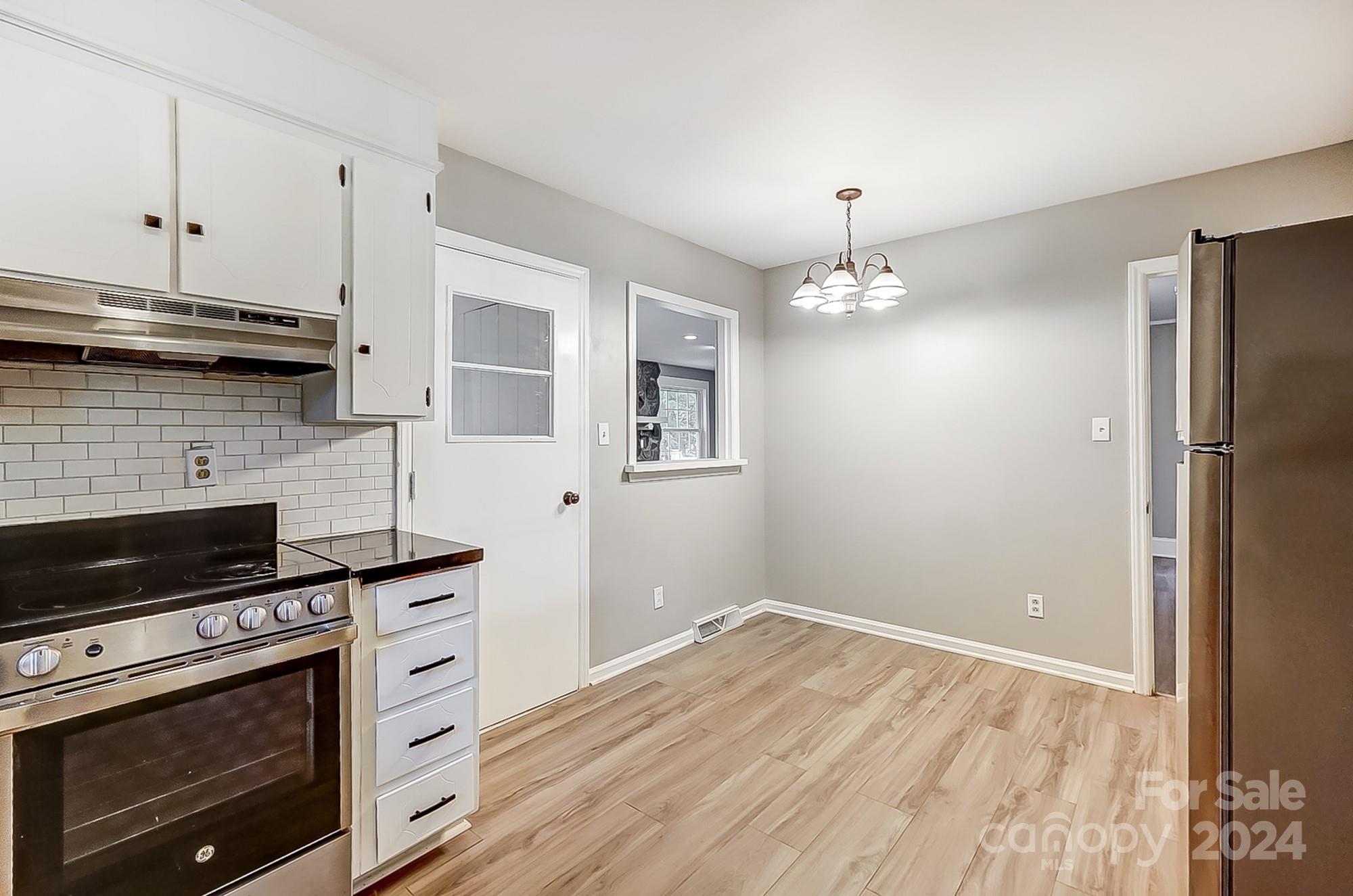 3218 Valley Grove Road Charlotte, NC 28227 - Photo 7 of 23 a kitchen with stainless steel appliances a stove and a refrigerator