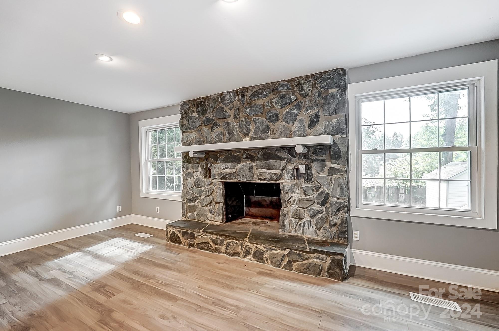3218 Valley Grove Road Charlotte, NC 28227 - Photo 10 of 23 a view of an empty room with wooden floor fireplace and a window