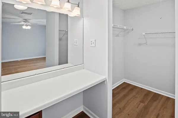a view of bathroom with a sink and mirror