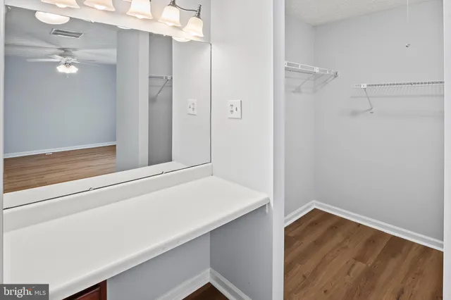 a view of bathroom with a sink and mirror