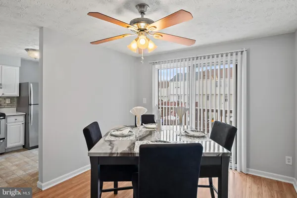 a view of a dining room with furniture and a chandelier