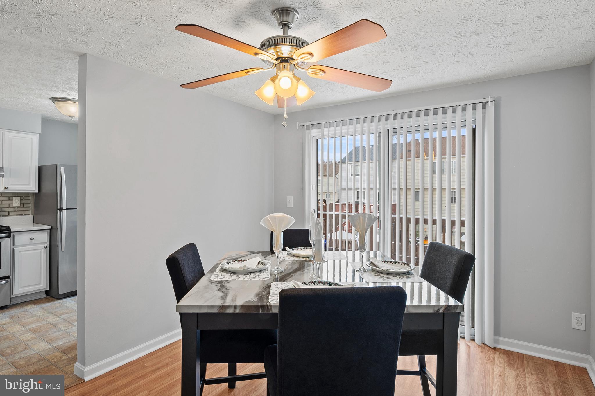 7346 Hidden Cove Columbia, MD 21046 - Photo 7 of 26 a view of a dining room with furniture and a chandelier