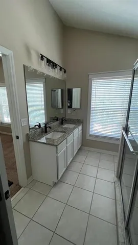 a bathroom with a sink a mirror and a bathtub
