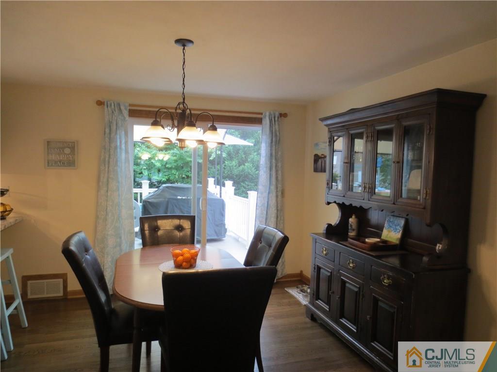235 Maple Avenue Dunellen, NJ 08812 - Photo 15 of 20 a dining room with furniture a chandelier and window