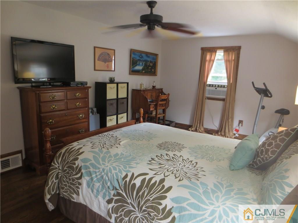 235 Maple Avenue Dunellen, NJ 08812 - Photo 17 of 20 a bedroom with a bed and a flat screen tv