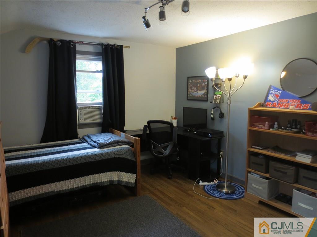 235 Maple Avenue Dunellen, NJ 08812 - Photo 19 of 20 a bedroom with a bed and wooden floor