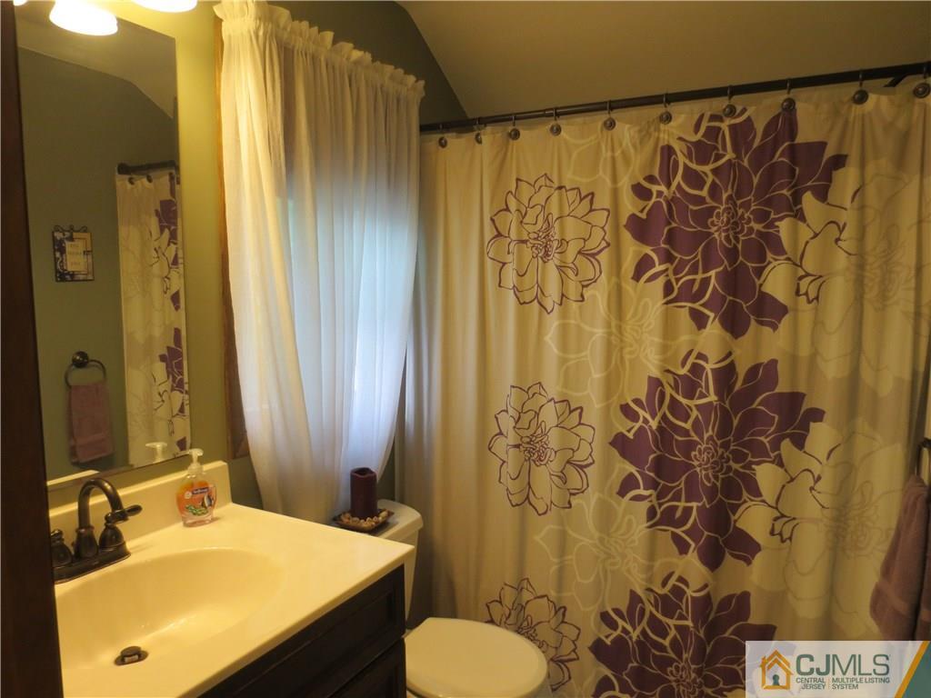 235 Maple Avenue Dunellen, NJ 08812 - Photo 20 of 20 a bathroom with a sink and a mirror