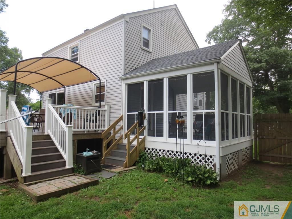 235 Maple Avenue Dunellen, NJ 08812 - Photo 4 of 20 a view of a house with wooden deck and a fence