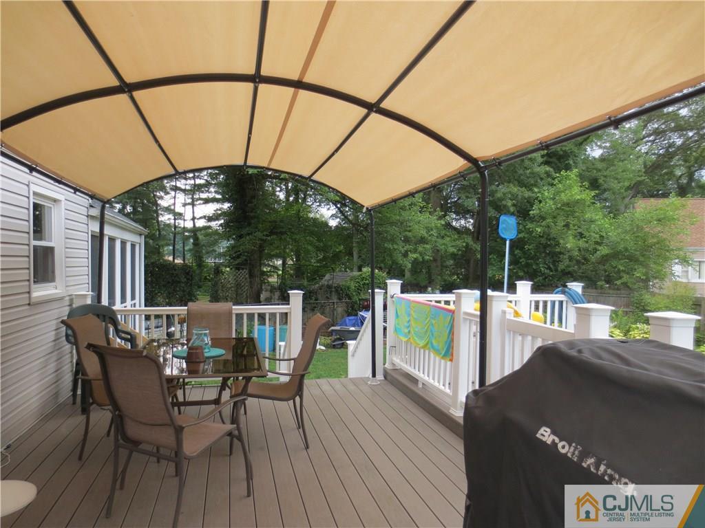 235 Maple Avenue Dunellen, NJ 08812 - Photo 6 of 20 a view of a deck with a table and chairs