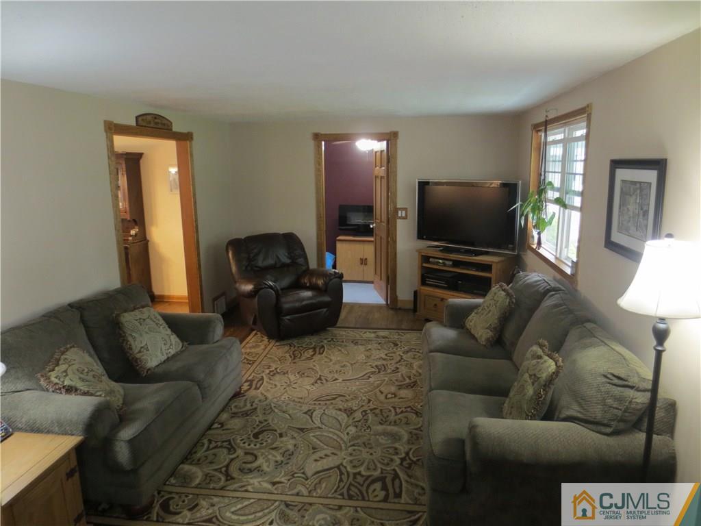 235 Maple Avenue Dunellen, NJ 08812 - Photo 9 of 20 a living room with furniture and a flat screen tv