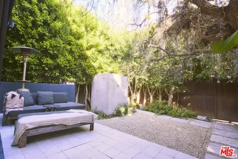 a backyard of a house with table and chairs