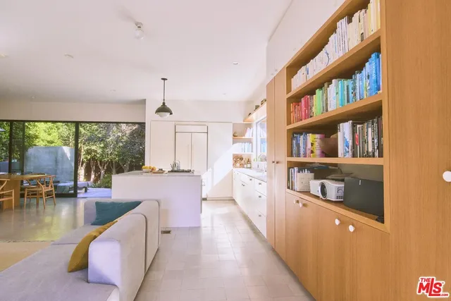 a living room with furniture and a floor to ceiling window