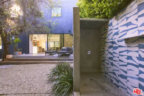 a view of a brick house with a bench in front of it