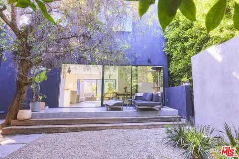 a living room with furniture and stairs