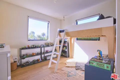 a bedroom with a bed and a painting on the wall