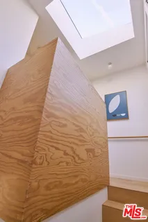 a living room with furniture and a book shelf