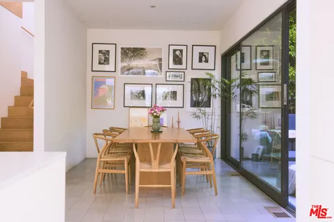 a view of a dining room with furniture and chandelier