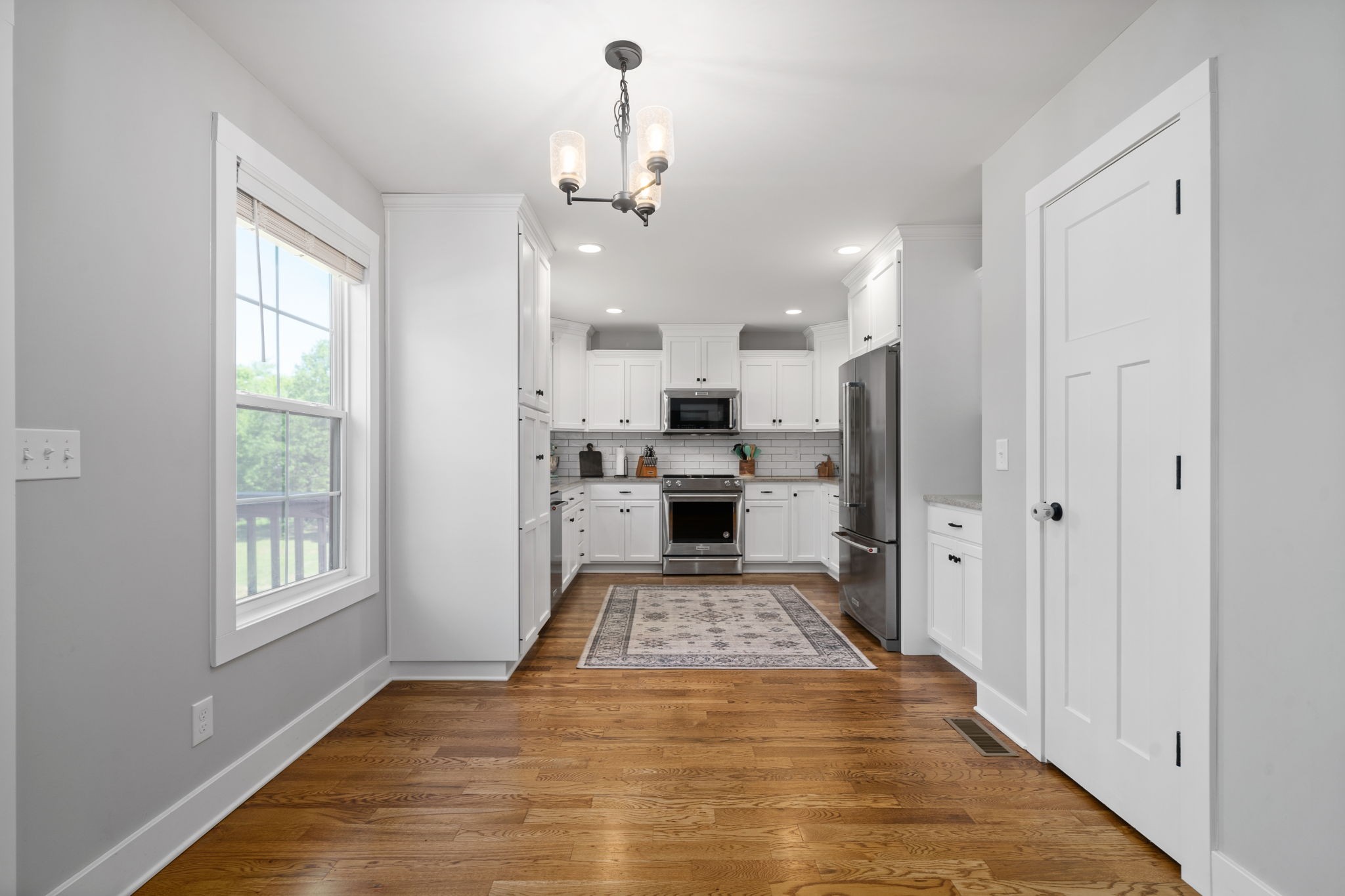 3744 McGregor Road Adams, TN 37010 - Photo 10 of 48 a view of a kitchen with a stove cabinets and wooden floor