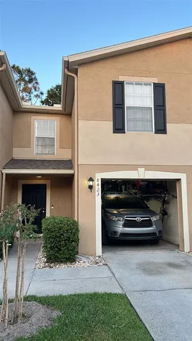 a view of house with car parked