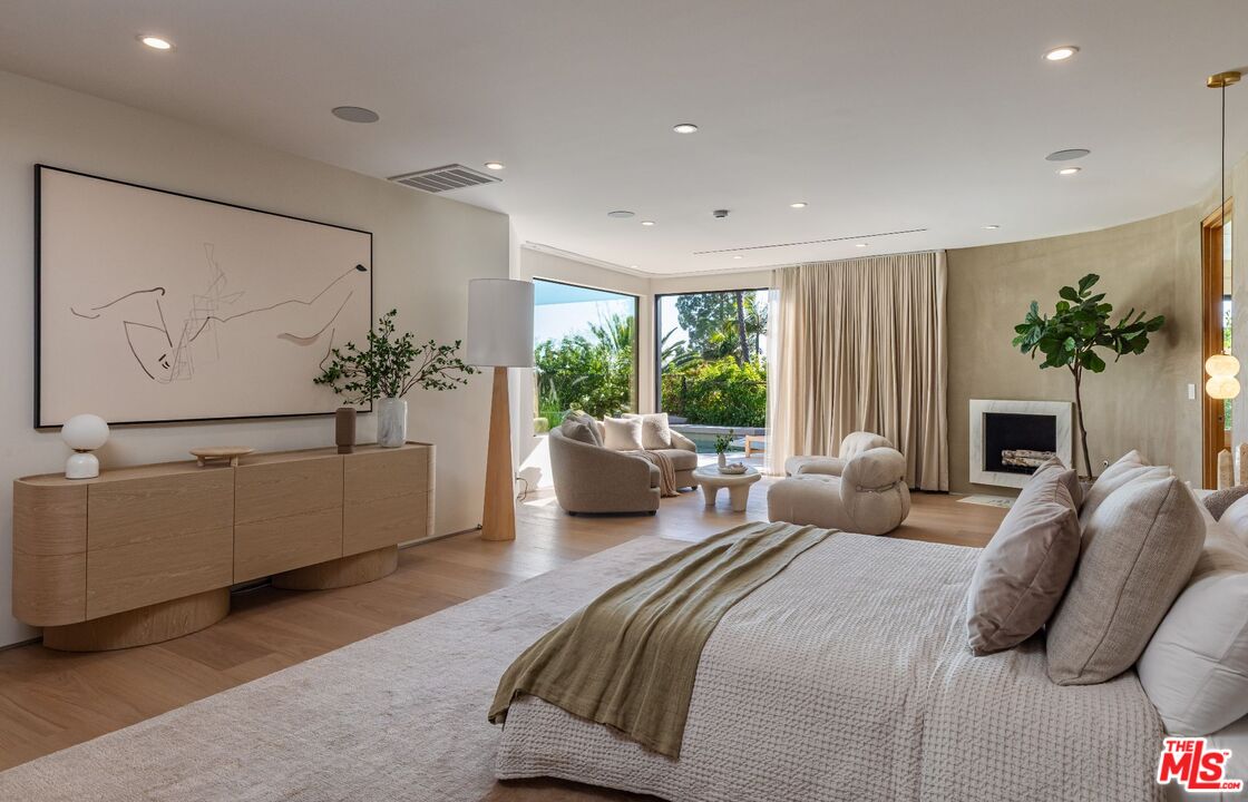 1705 Carla Ridge Beverly Hills, CA 90210 - Photo 12 of 39 a bedroom with a large bed and a couch