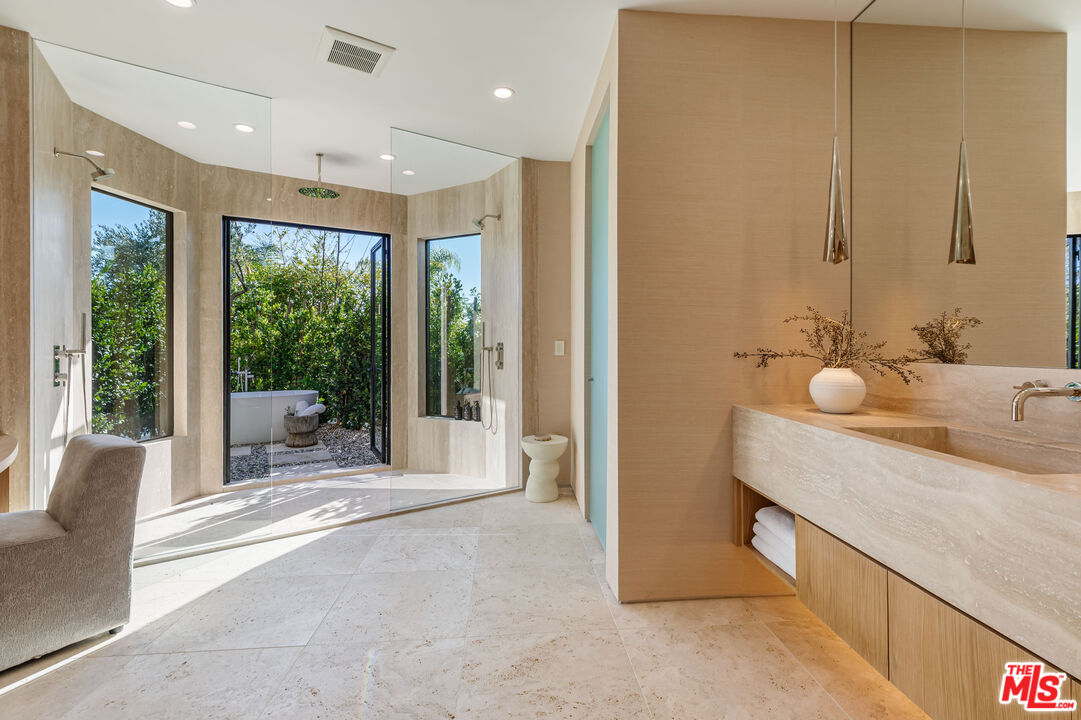 1705 Carla Ridge Beverly Hills, CA 90210 - Photo 14 of 39 a spacious bathroom with a double vanity sink and a large mirror