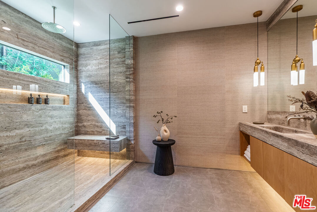 1705 Carla Ridge Beverly Hills, CA 90210 - Photo 17 of 39 a bathroom with a granite countertop sink a toilet and shower