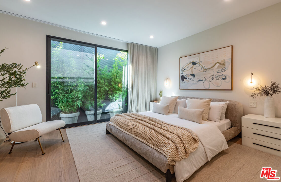 1705 Carla Ridge Beverly Hills, CA 90210 - Photo 18 of 39 a spacious bedroom with a large bed and a couch