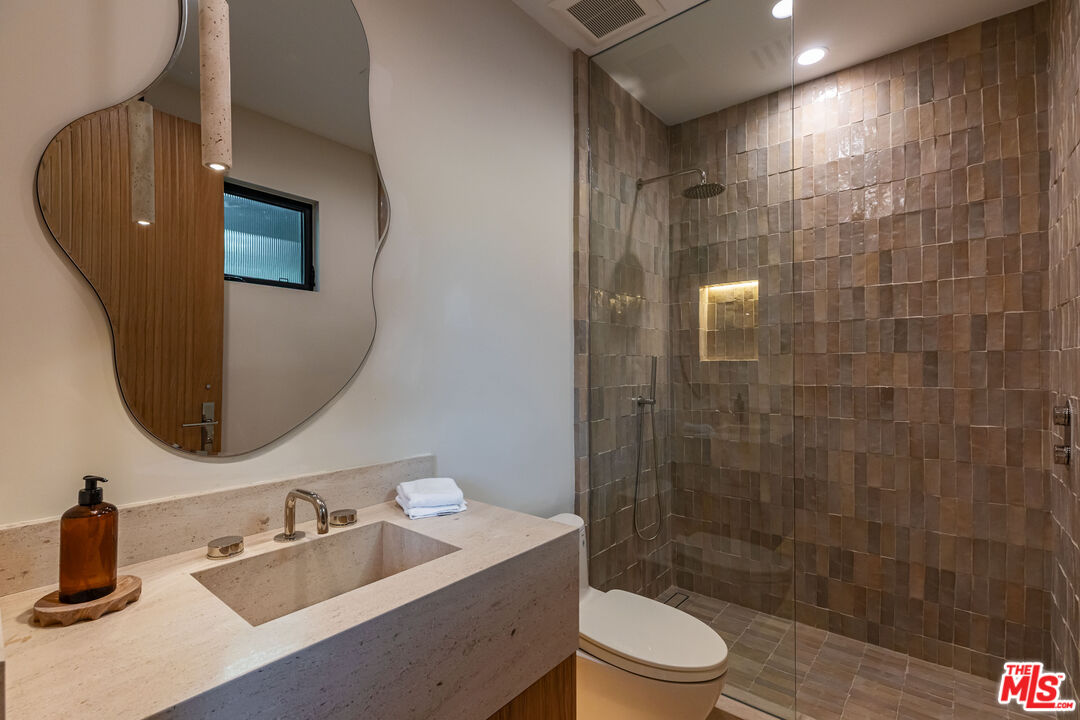 1705 Carla Ridge Beverly Hills, CA 90210 - Photo 21 of 39 a bathroom with a sink a toilet and shower